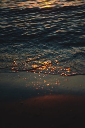 water droplets on body of water during daytime